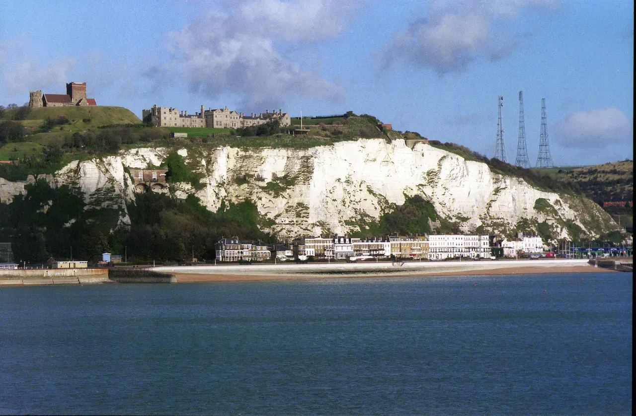 The white cliffs at Dover seen from the sea, with Dover Castle on the hill above the seafront