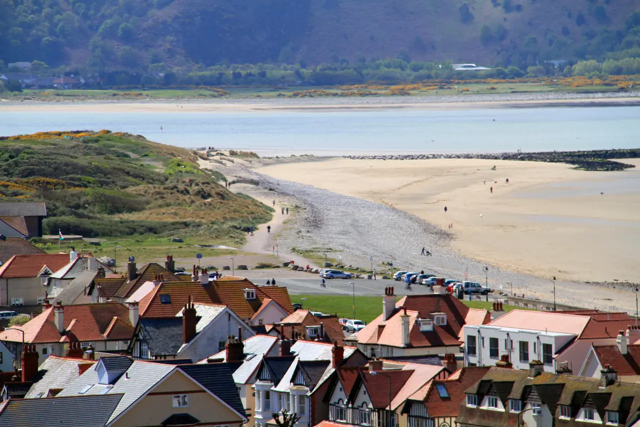 The West Shore seen from the Great Orme: a green, a long promenade road and miles of flat sand and estuary stretching towards Deganwy and the hills