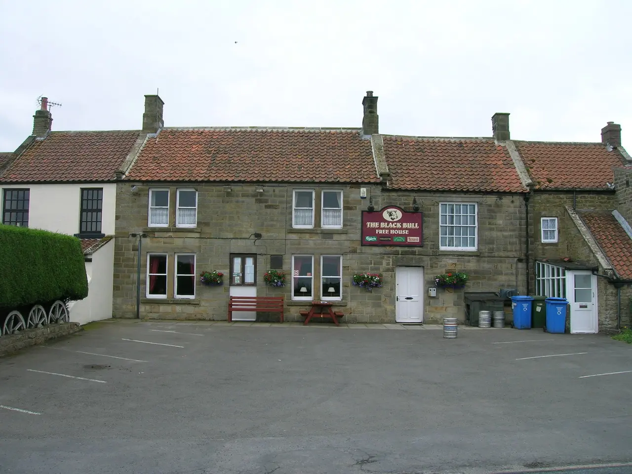 The Black Bull at Ugthorpe, a long stone pub with a red pantile roof and a car park in front