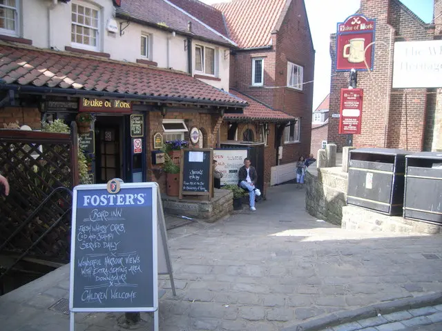 The Duke of York pub's red-tiled porch and entrance on Church Street, with a chalkboard outside