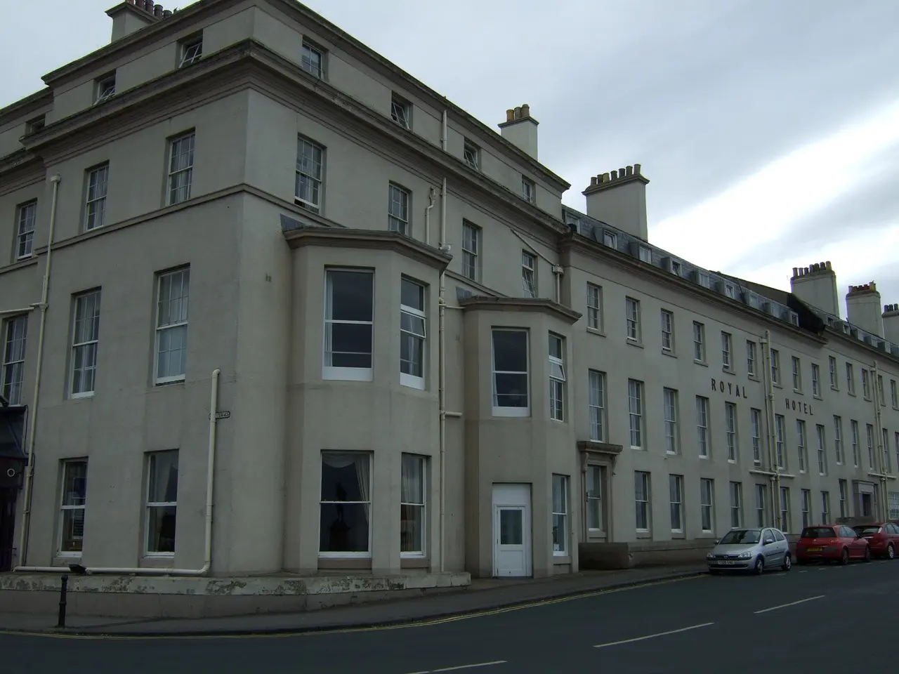 The long cream-painted front of the Royal Hotel on Whitby's West Cliff, seen from the street corner
