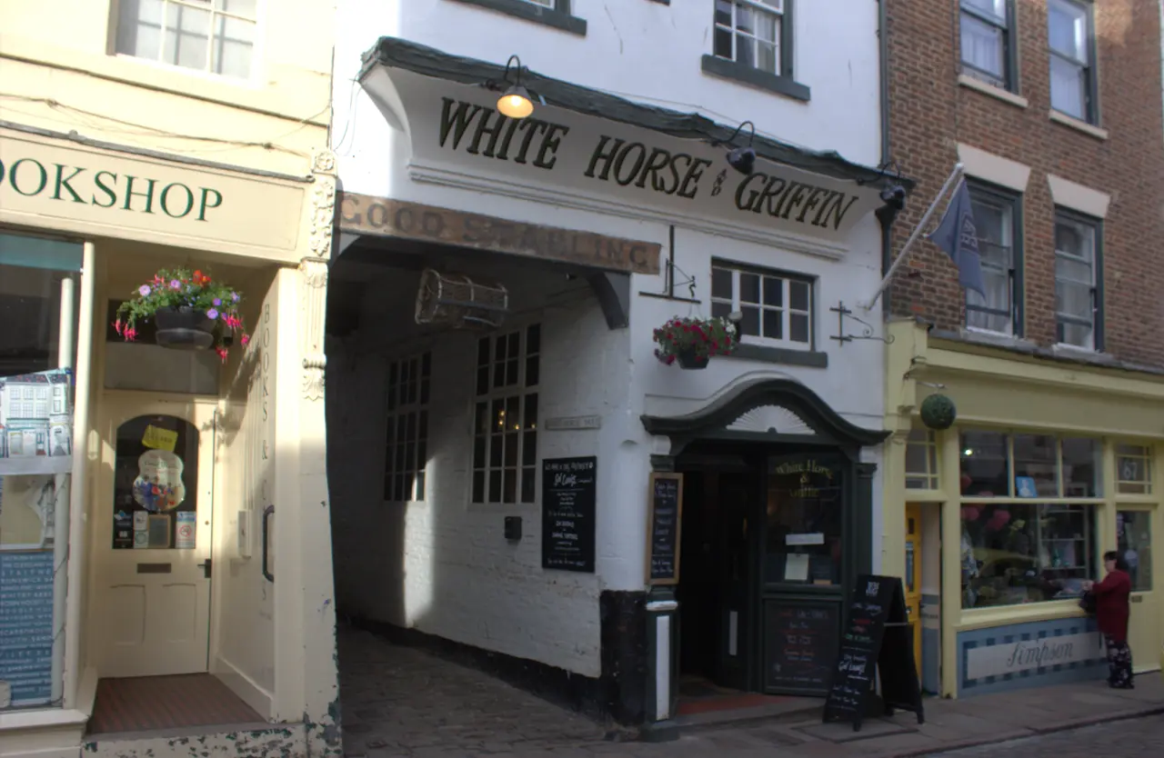 The White Horse & Griffin's white-painted front on Church Street, with its name over the door and a hanging basket